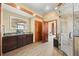 Elegant main bathroom with a granite countertop, custom vanity, and access to a glass-enclosed shower at 21016 Horse Bit Way, Morrison, CO 80465