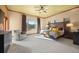 Sunlit main bedroom with a large bed, soft armchair, and panoramic views of the lush green landscape at 21016 Horse Bit Way, Morrison, CO 80465