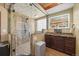 Luxurious shower featuring decorative pebble flooring, bench seating, and a rainfall showerhead at 21016 Horse Bit Way, Morrison, CO 80465