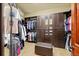 Spacious walk-in closet with custom shelving, drawers, and ample storage for clothing and accessories at 21016 Horse Bit Way, Morrison, CO 80465