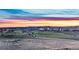 Scenic aerial view of the community with lush green landscape and colorful sunset sky at 2144 Rosette Ln, Castle Rock, CO 80104