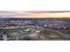 Wide aerial view of a Gathering-friendly community featuring homes, open spaces, and recreational areas at sunset at 2144 Rosette Ln, Castle Rock, CO 80104