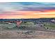 Scenic aerial view of the community with lush green landscape and beautiful sunset sky at 2144 Rosette Ln, Castle Rock, CO 80104