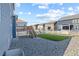 Expansive backyard with low-maintenance gravel landscaping, a deck, and a green artificial turf area at 2144 Rosette Ln, Castle Rock, CO 80104