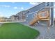 Spacious backyard with a charming deck and a lush, green artificial turf area, perfect for outdoor activities at 2144 Rosette Ln, Castle Rock, CO 80104