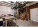 Unfinished basement with exposed ceiling, a workbench, and a utility area with ample storage space at 2144 Rosette Ln, Castle Rock, CO 80104