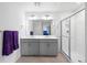 Bright bathroom featuring a double sink vanity, a glass shower and tiled floors at 2144 Rosette Ln, Castle Rock, CO 80104