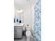 Bright bathroom with white walls, a blue seashell shower curtain, and gray vanity at 2144 Rosette Ln, Castle Rock, CO 80104