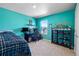 Bright bedroom features a built-in desk and shelving unit with a window overlooking neighborhood at 2144 Rosette Ln, Castle Rock, CO 80104