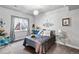 Charming bedroom with a comfortable bed, decorative accents, and soft natural light from the large window at 2144 Rosette Ln, Castle Rock, CO 80104