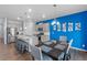 Open kitchen with a dining area featuring modern light fixtures and stainless appliances at 2144 Rosette Ln, Castle Rock, CO 80104