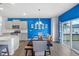 Bright kitchen and dining space with stylish light fixtures and sliding door access at 2144 Rosette Ln, Castle Rock, CO 80104