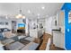 Open concept kitchen and dining area featuring modern light fixtures, an island, and stainless steel appliances at 2144 Rosette Ln, Castle Rock, CO 80104