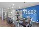 Contemporary kitchen and dining area with granite countertops, stainless steel appliances, and stylish lighting fixtures at 2144 Rosette Ln, Castle Rock, CO 80104