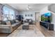 Comfortable living room featuring a plush sofa, decorative shelving and a large window for ample natural light at 2144 Rosette Ln, Castle Rock, CO 80104