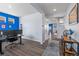 Open-concept living area with hardwood floors and bright blue accent wall at 2144 Rosette Ln, Castle Rock, CO 80104