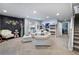 Finished basement offering neutral walls, comfortable seating, and stairs leading to upper level at 2144 Rosette Ln, Castle Rock, CO 80104