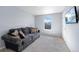 Light-filled living room with a comfortable couch and large window with a view of the neighborhood at 2144 Rosette Ln, Castle Rock, CO 80104