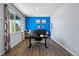 Bright home office with hardwood floors, large window, and bold blue accent wall at 2144 Rosette Ln, Castle Rock, CO 80104
