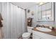 Clean bathroom with shower/tub combo, vanity, and linen storage at 1196 N Grant St # 710, Denver, CO 80203