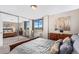 Spacious bedroom with mirrored closet doors and a view at 1196 N Grant St # 710, Denver, CO 80203