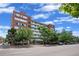 Brick apartment building with landscaping and street parking at 1196 N Grant St # 710, Denver, CO 80203