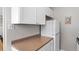 White kitchen cabinets and countertops with a refrigerator and microwave at 1196 N Grant St # 710, Denver, CO 80203