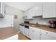 Efficient galley kitchen features white cabinetry, modern appliances, and light brown countertops at 1196 N Grant St # 710, Denver, CO 80203