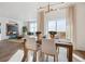 A well-lit dining room with a modern chandelier, seamlessly connected to the spacious living room at 4530 Cattle Cross Trl, Castle Rock, CO 80104