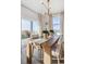 Bright dining room featuring a wood table, modern chandelier, and sliding glass doors to the backyard at 4530 Cattle Cross Trl, Castle Rock, CO 80104