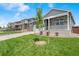 Attractive home featuring a well-maintained lawn, a small front porch, and stone detailing at 4530 Cattle Cross Trl, Castle Rock, CO 80104