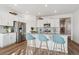 Modern kitchen with stainless steel appliances, a gray countertop island, and light-blue barstools at 4530 Cattle Cross Trl, Castle Rock, CO 80104