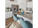 Modern kitchen with stainless steel appliances, a gray countertop island, and light-blue barstools at 4530 Cattle Cross Trl, Castle Rock, CO 80104