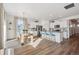 Open-concept kitchen and dining area with a gray countertop island, modern dining table, and white cabinets at 4530 Cattle Cross Trl, Castle Rock, CO 80104