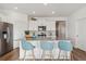 Modern kitchen featuring stainless steel appliances, a gray countertop island, and light-blue barstools at 4530 Cattle Cross Trl, Castle Rock, CO 80104