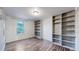 Bright bedroom with a window and ample shelving storage on the sides at 12260 E Bates Cir, Aurora, CO 80014