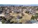 Aerial view of a neighborhood with a park featuring pathways and a playground at 12260 E Bates Cir, Aurora, CO 80014