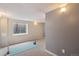 Neutral colored basement with a yoga mat and plenty of natural light from the window at 13439 Antlers St, Broomfield, CO 80020