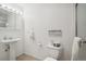 Bright bathroom with a pedestal sink, modern fixtures, and a decorative sign above the toilet at 13439 Antlers St, Broomfield, CO 80020