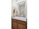 Cozy bathroom includes a vanity and mirror with decorative lighting and towel rack at 13439 Antlers St, Broomfield, CO 80020