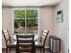 Dining area featuring a window with a view to the green backyard and stone retaining wall at 13439 Antlers St, Broomfield, CO 80020