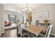 Elegant dining room with a rustic table and views into the living room and kitchen at 13439 Antlers St, Broomfield, CO 80020