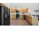 This kitchen boasts stainless steel appliances, granite countertops, and beautiful wood flooring at 13439 Antlers St, Broomfield, CO 80020