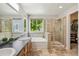 A bright main bathroom features dual sinks, soaking tub, and stand-alone shower at 13439 Antlers St, Broomfield, CO 80020