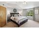 A cozy main bedroom features neutral tones, tray ceilings, and abundant natural light at 13439 Antlers St, Broomfield, CO 80020