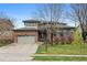 Charming two-story home featuring brick accents, a well-manicured lawn, and a spacious driveway at 13250 Wild Basin Way, Broomfield, CO 80020
