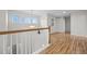 Bright hallway featuring hardwood floors, leading to more rooms in the house at 13250 Wild Basin Way, Broomfield, CO 80020