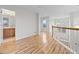 Well-lit upstairs hallway with hardwood floors and view of the bathroom at 13250 Wild Basin Way, Broomfield, CO 80020