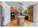 Well-equipped kitchen with wood cabinets, an island, modern appliances, and hardwood flooring, ideal for cooking at 13250 Wild Basin Way, Broomfield, CO 80020