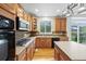 Functional kitchen featuring wood cabinetry, modern appliances, and a window overlooking the backyard, adding charm at 13250 Wild Basin Way, Broomfield, CO 80020